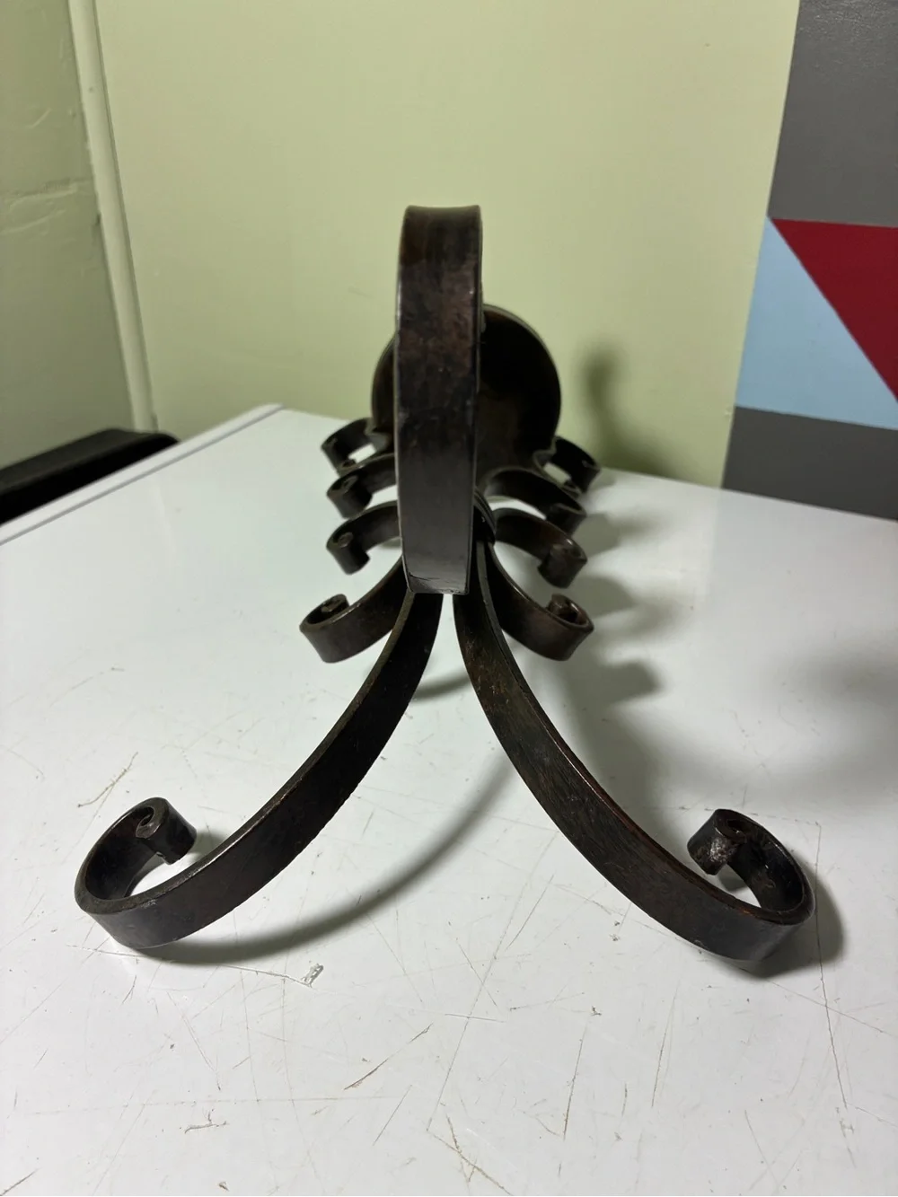 vintage wrought iron candle holder features a dark metal scroll and ring design